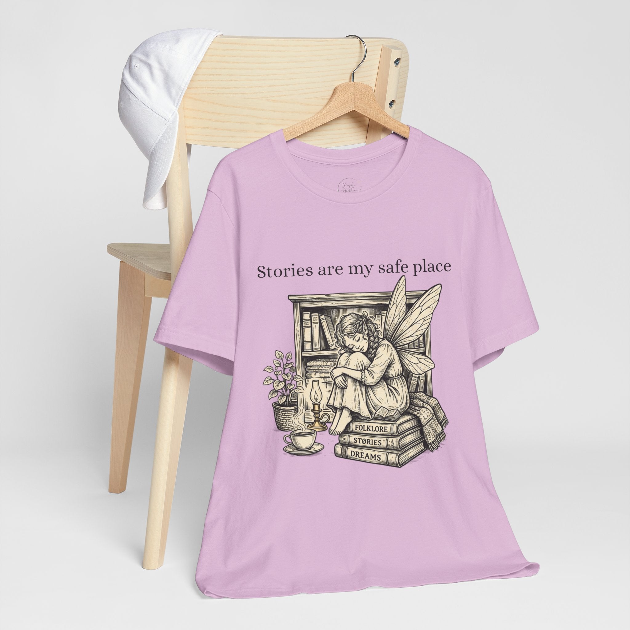 Fairy reading booklover T-shirt with "Stories Are My Safe Place" print, casual graphic tee for book enthusiasts and fairy fans.