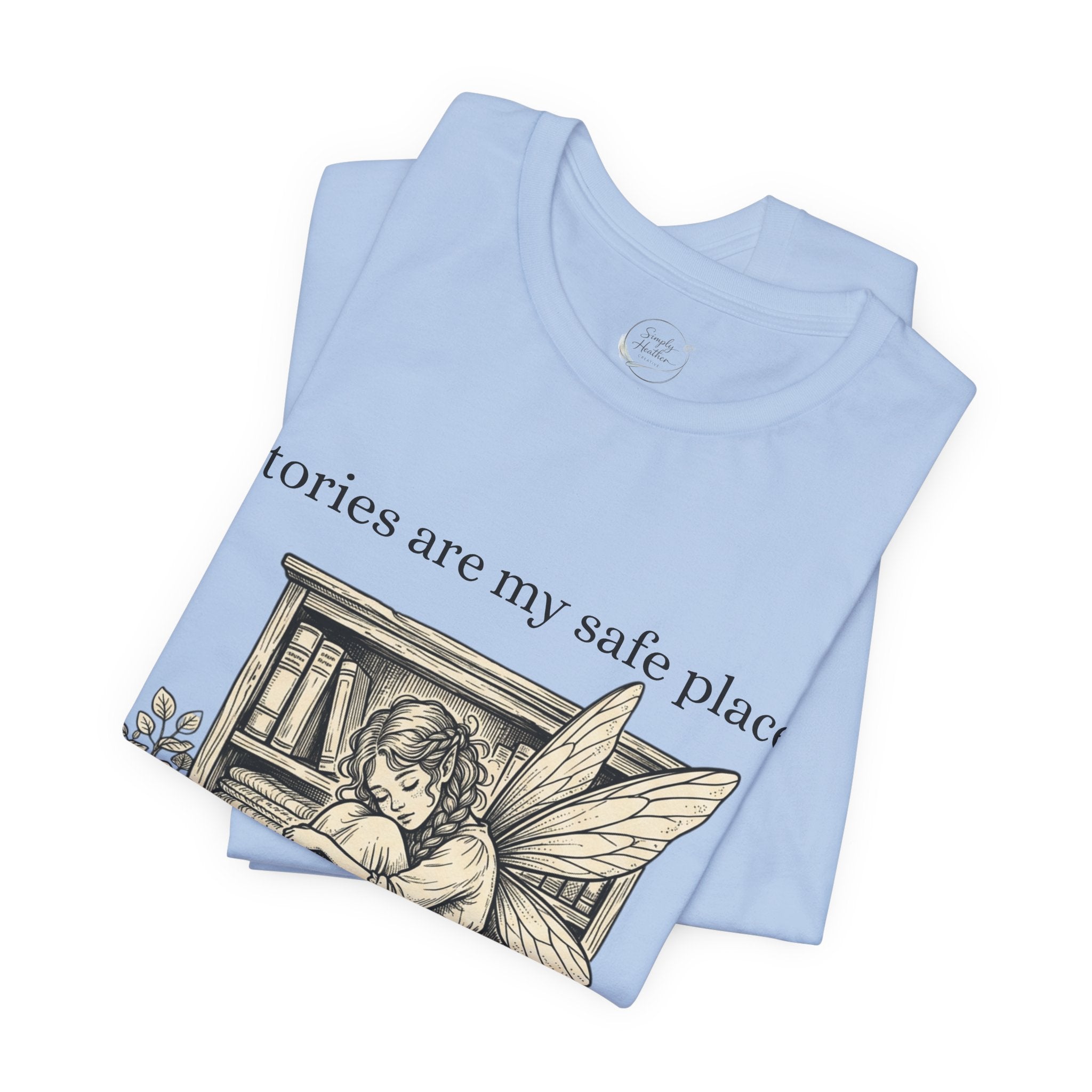 Soft white T-shirt featuring a fairy reading a book with the phrase "Stories Are My Safe Place" printed on the front.