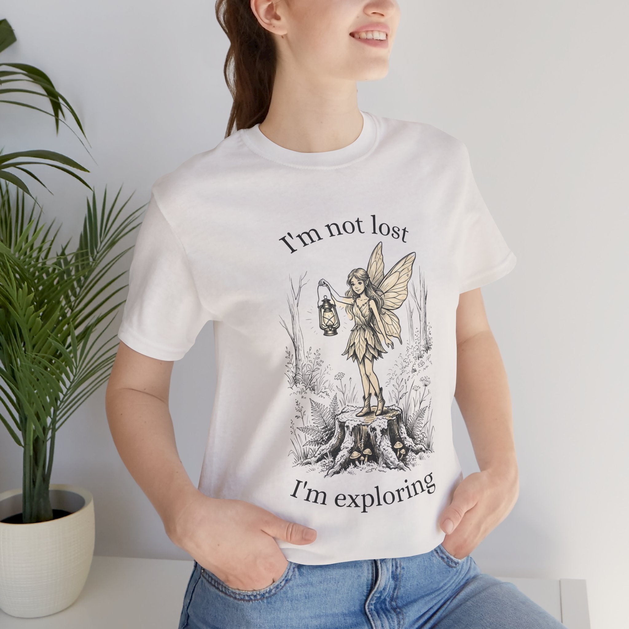 Fairy Exploration T-Shirt by Printify featuring a graphic with "I’m Not Lost, I’m Exploring" slogan, casual cotton tee for outdoor adventures