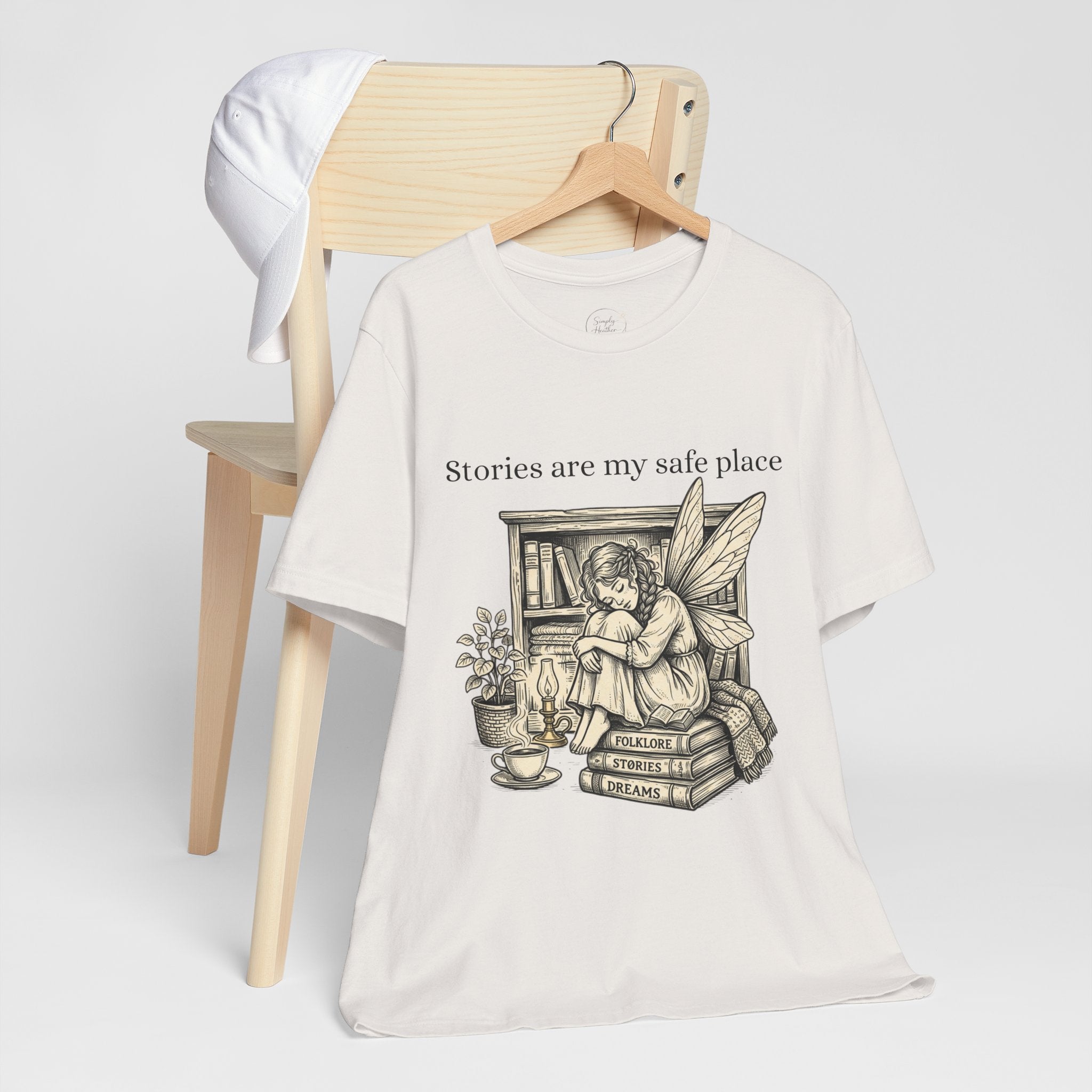 Fairy reading booklover T-shirt featuring "Stories Are My Safe Place" slogan, casual printify tee for book enthusiasts.