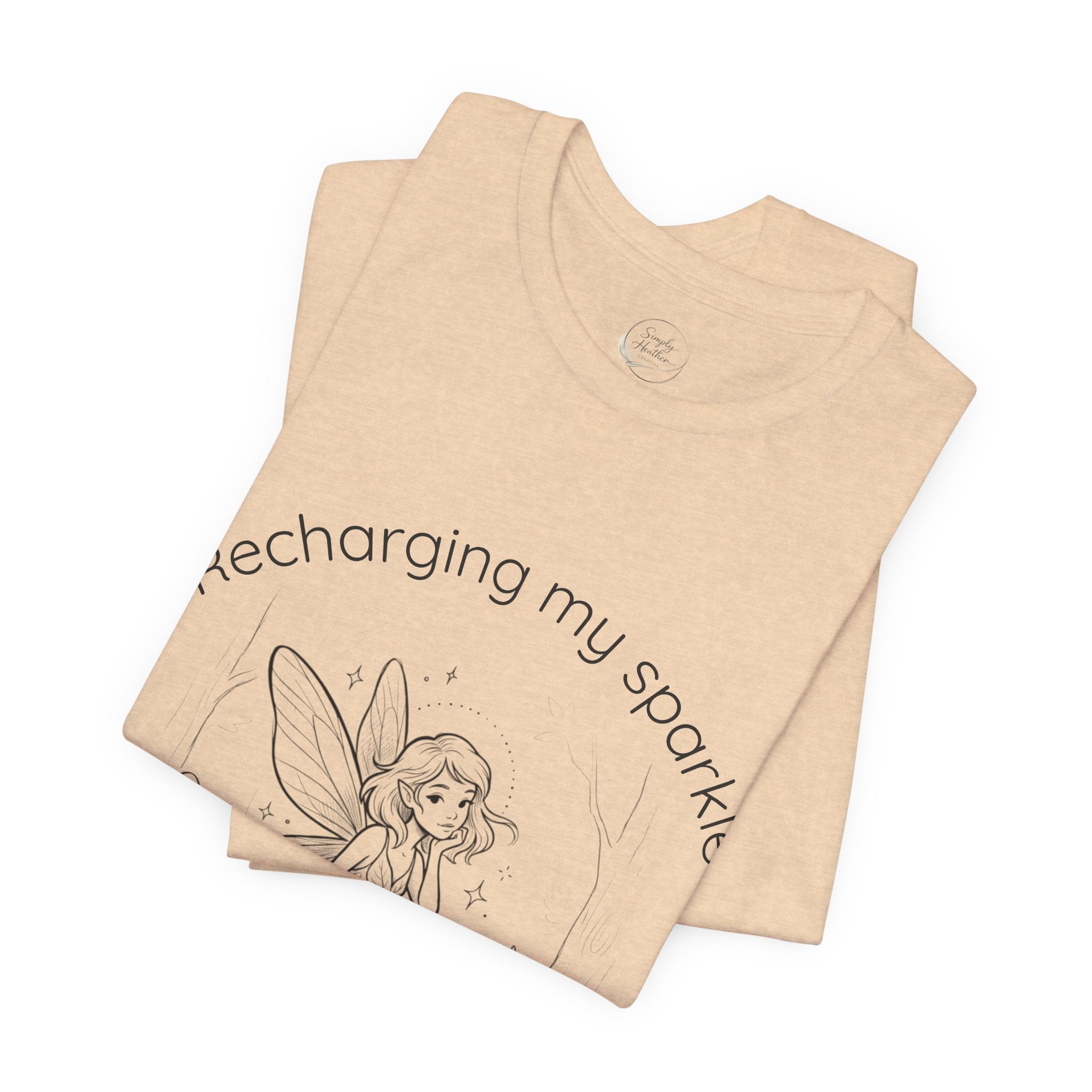Vintage fairy graphic T-shirt with "Recharging My Sparkle" slogan, featuring colorful fairy illustration on a casual Printify tee.