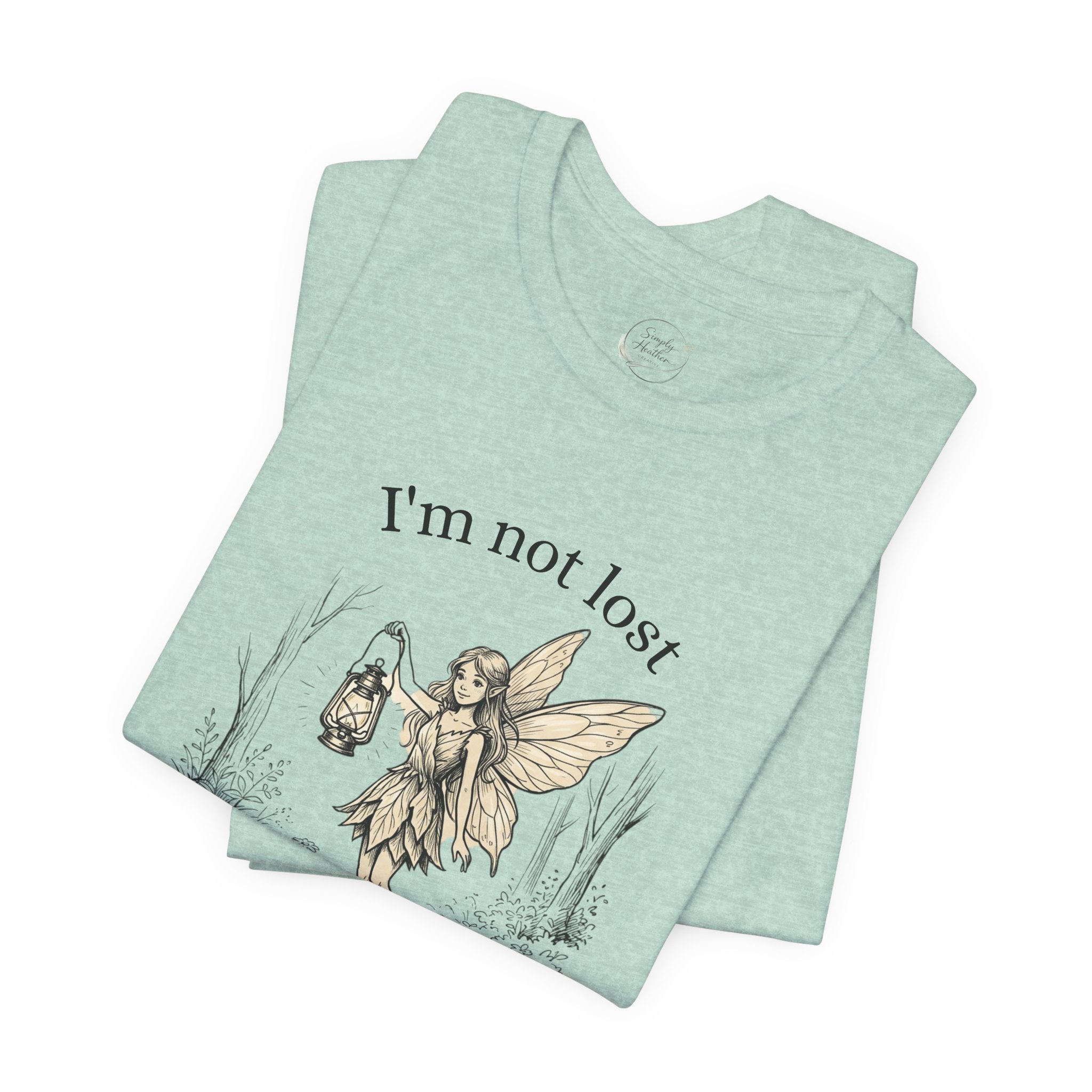 Fairy Exploration Tee with "I’m Not Lost, I’m Exploring" graphic t-shirt, featuring a whimsical fairy design by Printify.