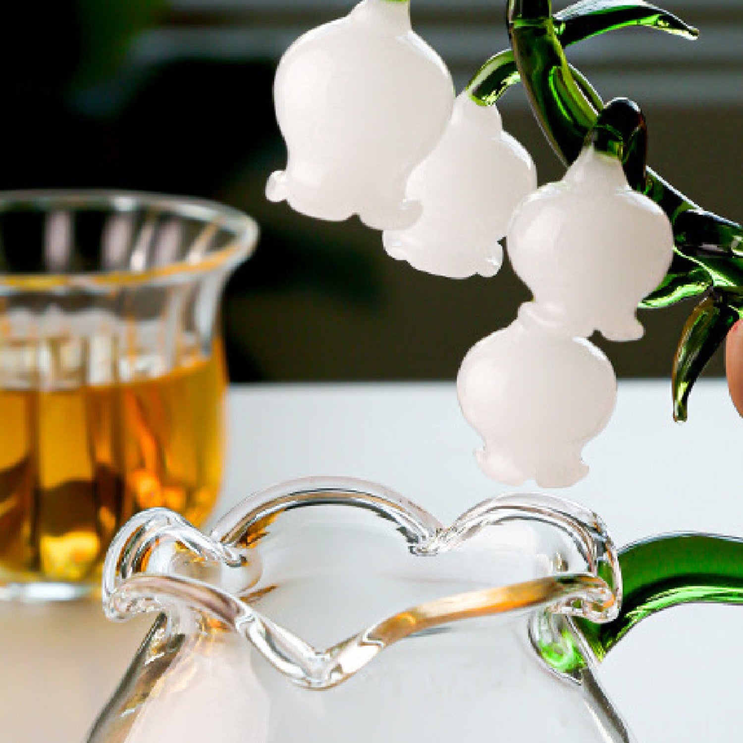 Hand-blown Bellflower glass teapot with matching cup from 24 Hour Crafts, featuring artisan floral design and clear glass craftsmanship.