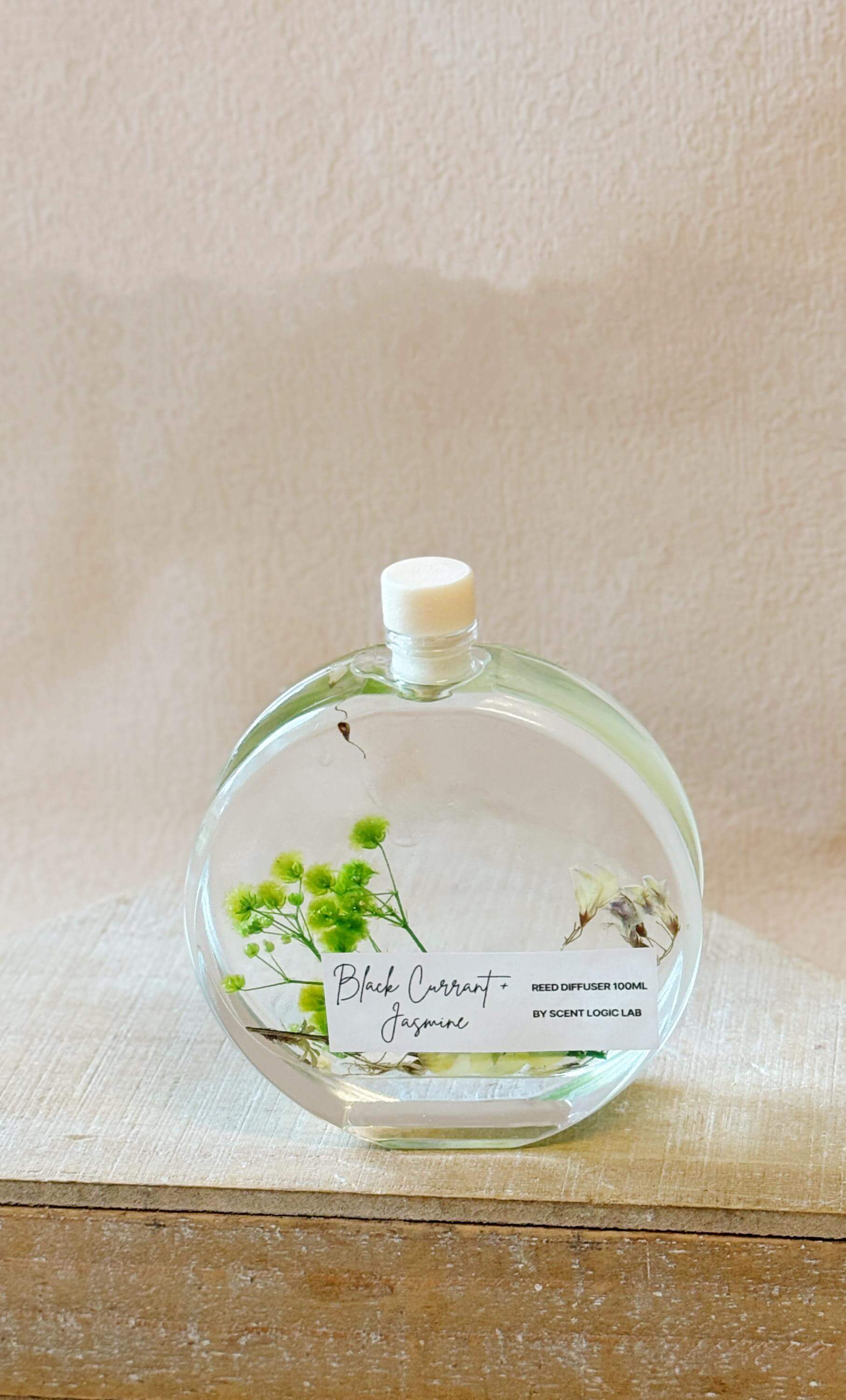 Handmade Lumenwood Apothecary Essence reed diffuser with botanical design, 100 ml glass bottle, for home fragrance and decor.