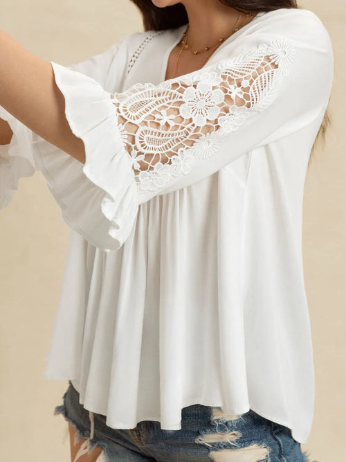 White lace flounce sleeve blouse with V-neck detail, showing intricate lace pattern and feminine design from a side view.