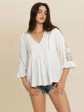 White lace blouse with flounce sleeves and V-neck, featuring a romantic cottage-inspired design by Trendsi.