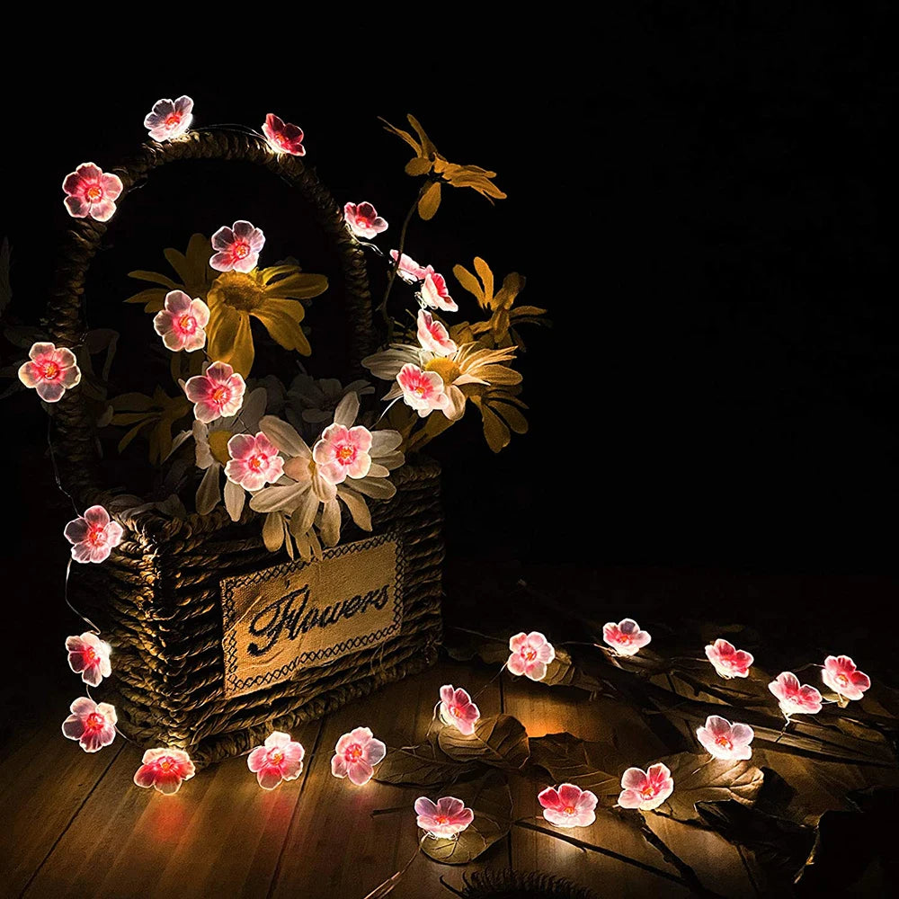 Cherry blossom fairy string lights with 20/30 LED soft glow bulbs, decorative floral garland for home and garden lighting.