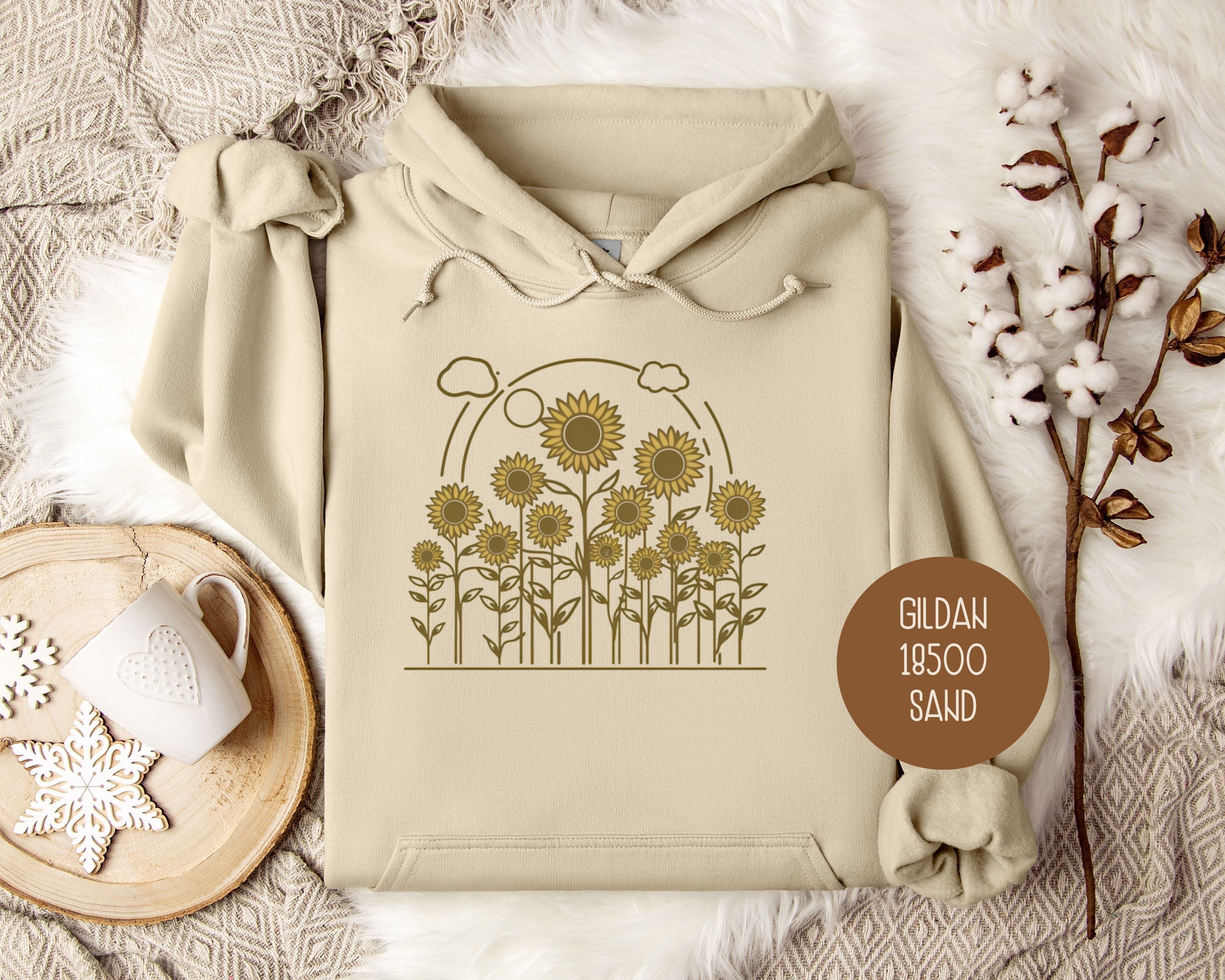 Golden Cottage Sunflower hoodie by CreativeSpecialTs featuring a sunflower design on the front, in a sand color.