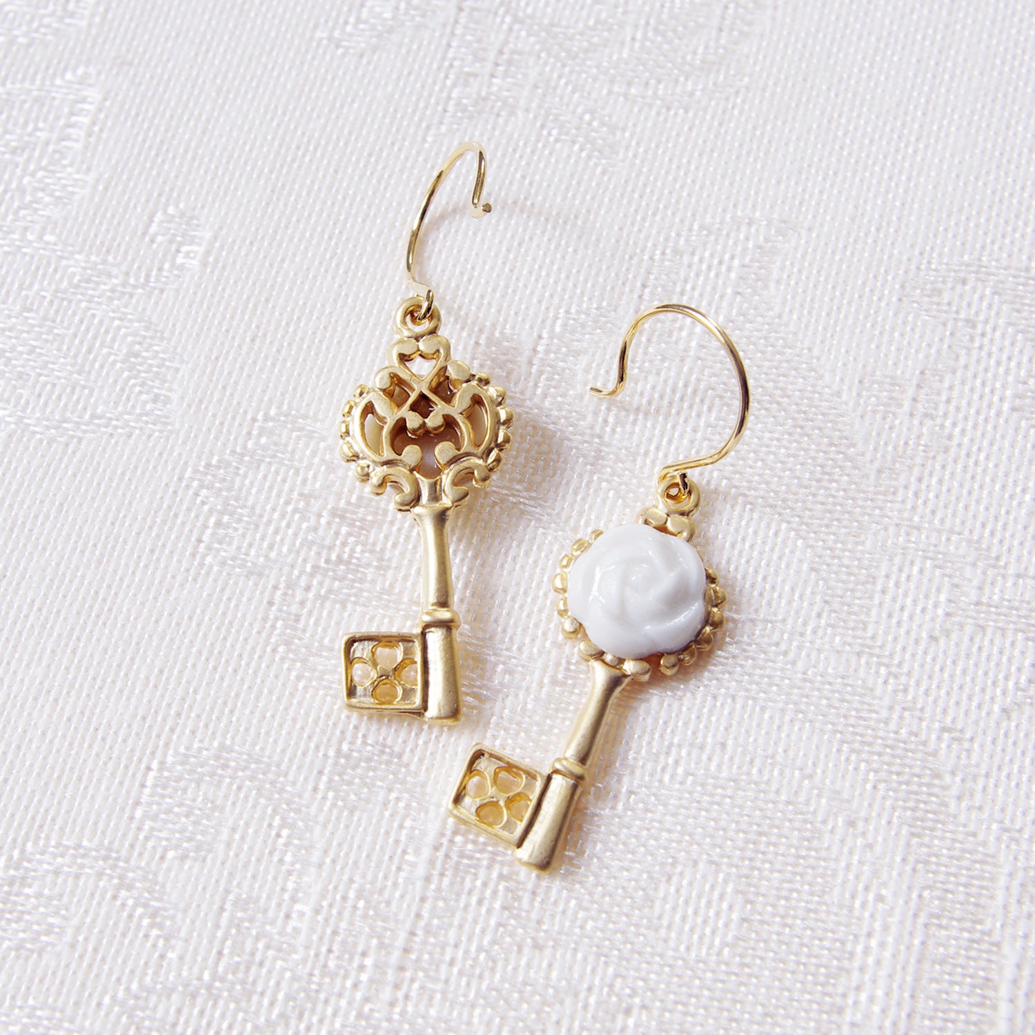 Back view of POPORCELAIN Porcelain Camellia Golden Key Earrings from Rosehaven Secret Garden Collection, showcasing intricate gold floral design.