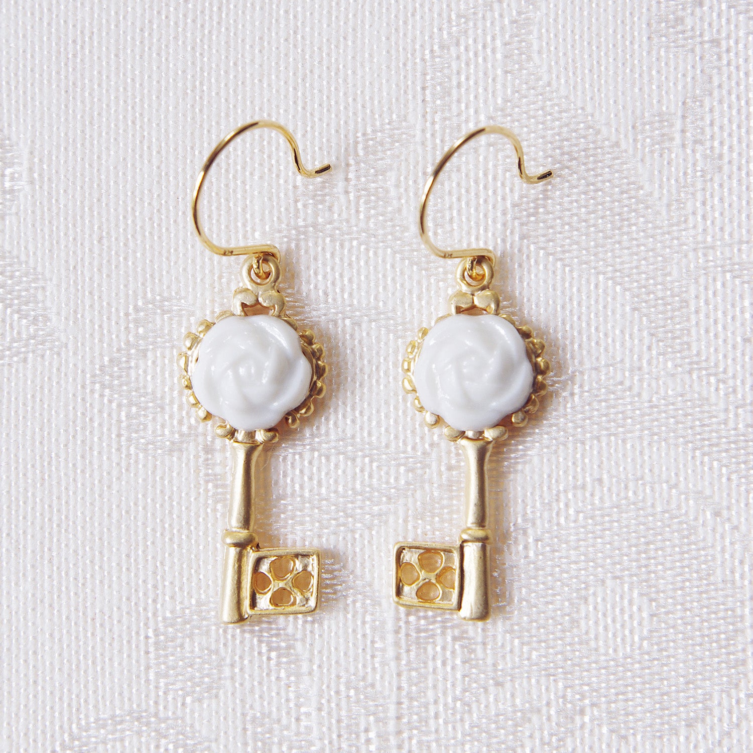 Golden porcelain Camellia key earrings by POPORCELAIN from the Rosehaven Secret Garden collection with gold-plated sterling silver hooks.