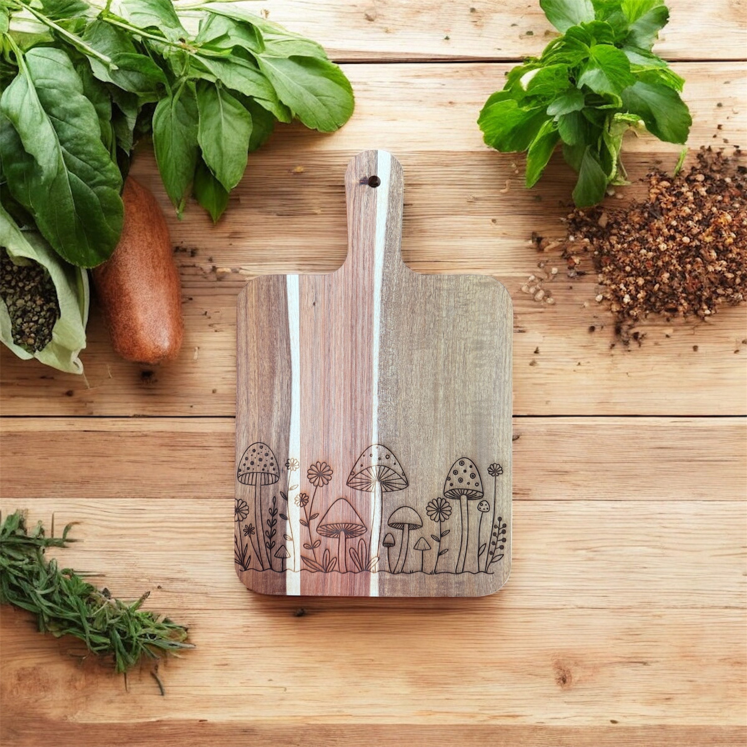 Hand-engraved mushroom design on acacia wood cutting board by The McGarvey Workshop, showcasing detailed craftsmanship.