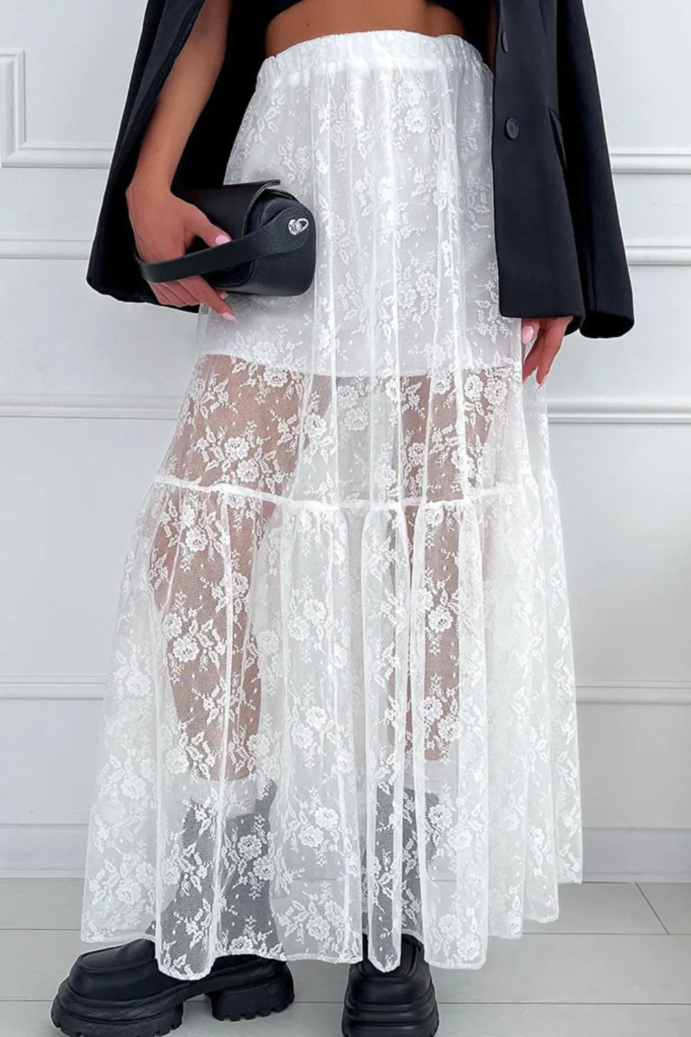 White lace maxi skirt from Trendsi featuring intricate lace fabric and a flowing, elegant design, front view.
