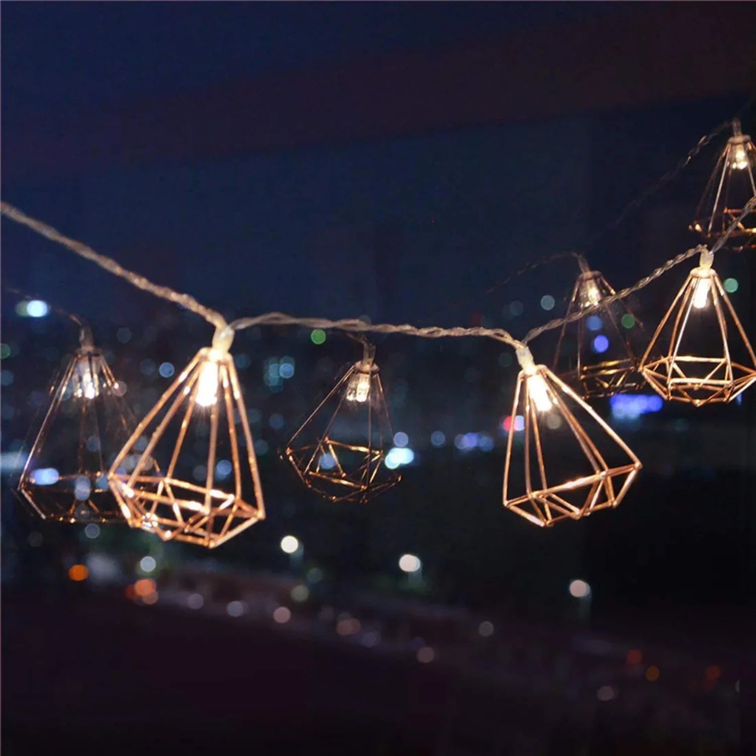 Lit-up rose gold geometric LED string fairy lights by Perfect Holiday, battery-operated decorative lights for home or events.