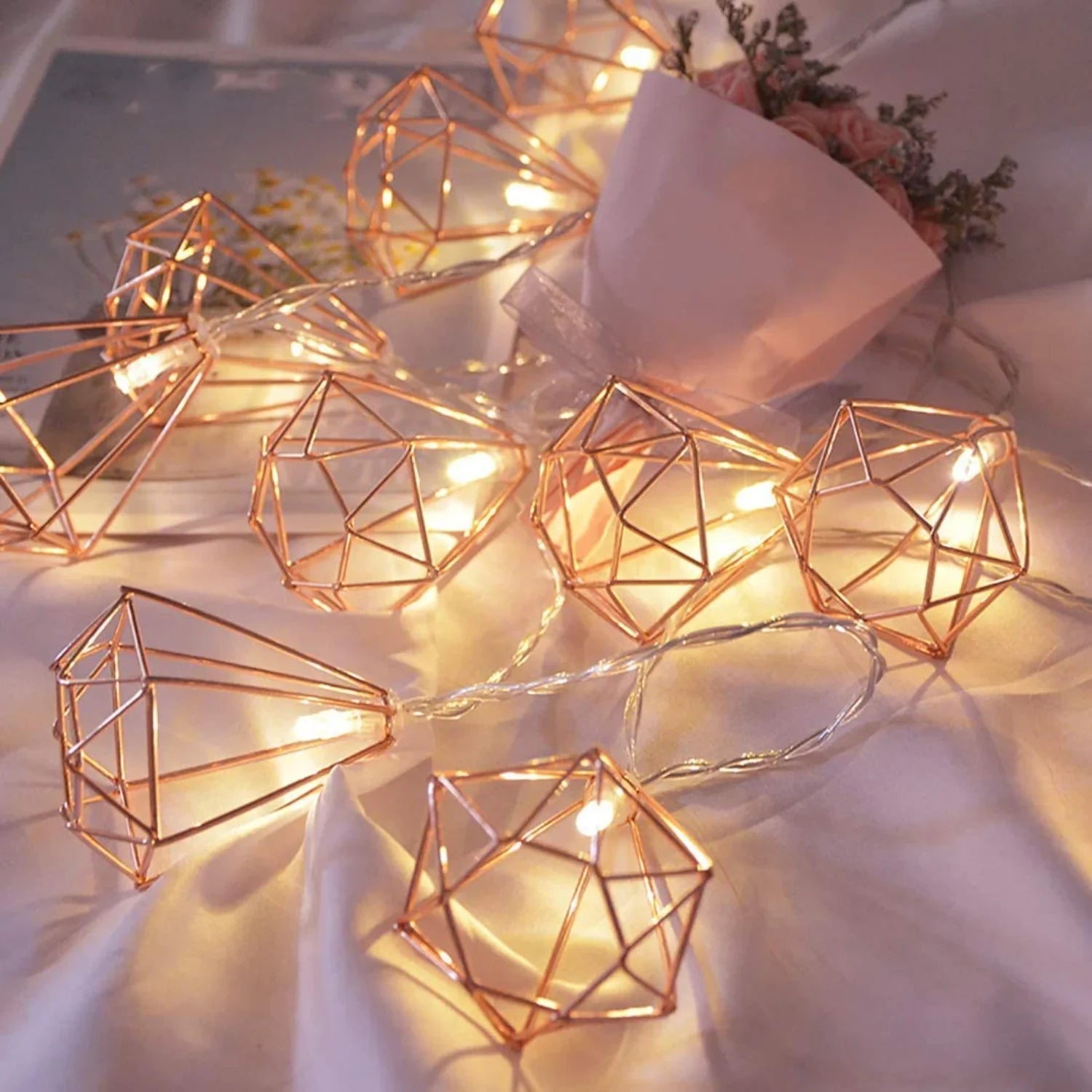 Rose gold diamond string fairy lights with warm white LEDs, battery operated, perfect for decorative holiday or home accents.