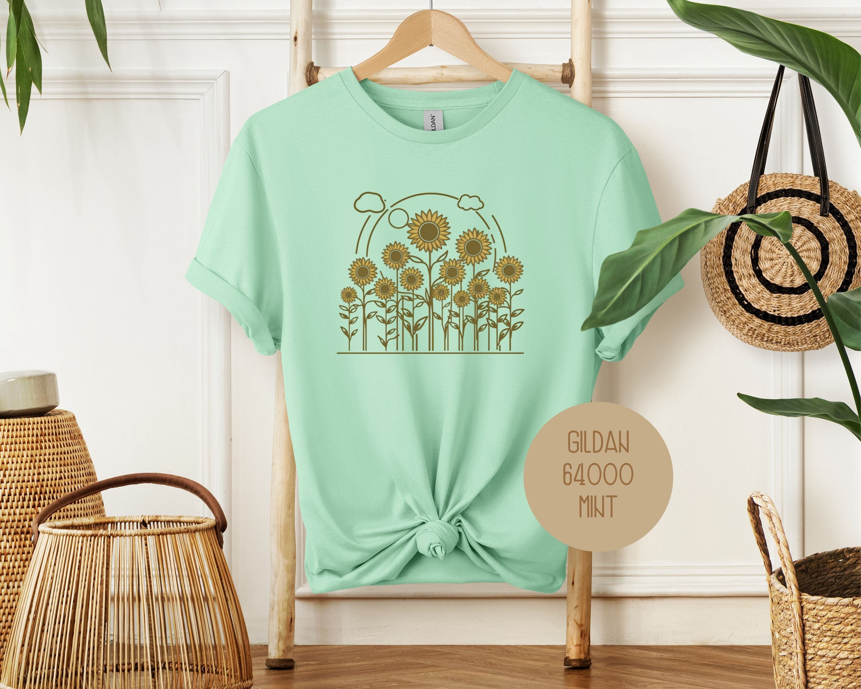 Mint green Rosehaven Cottage vintage sunflower T-shirt by CreativeSpecialTs, front view showcasing floral graphic and relaxed fit.
