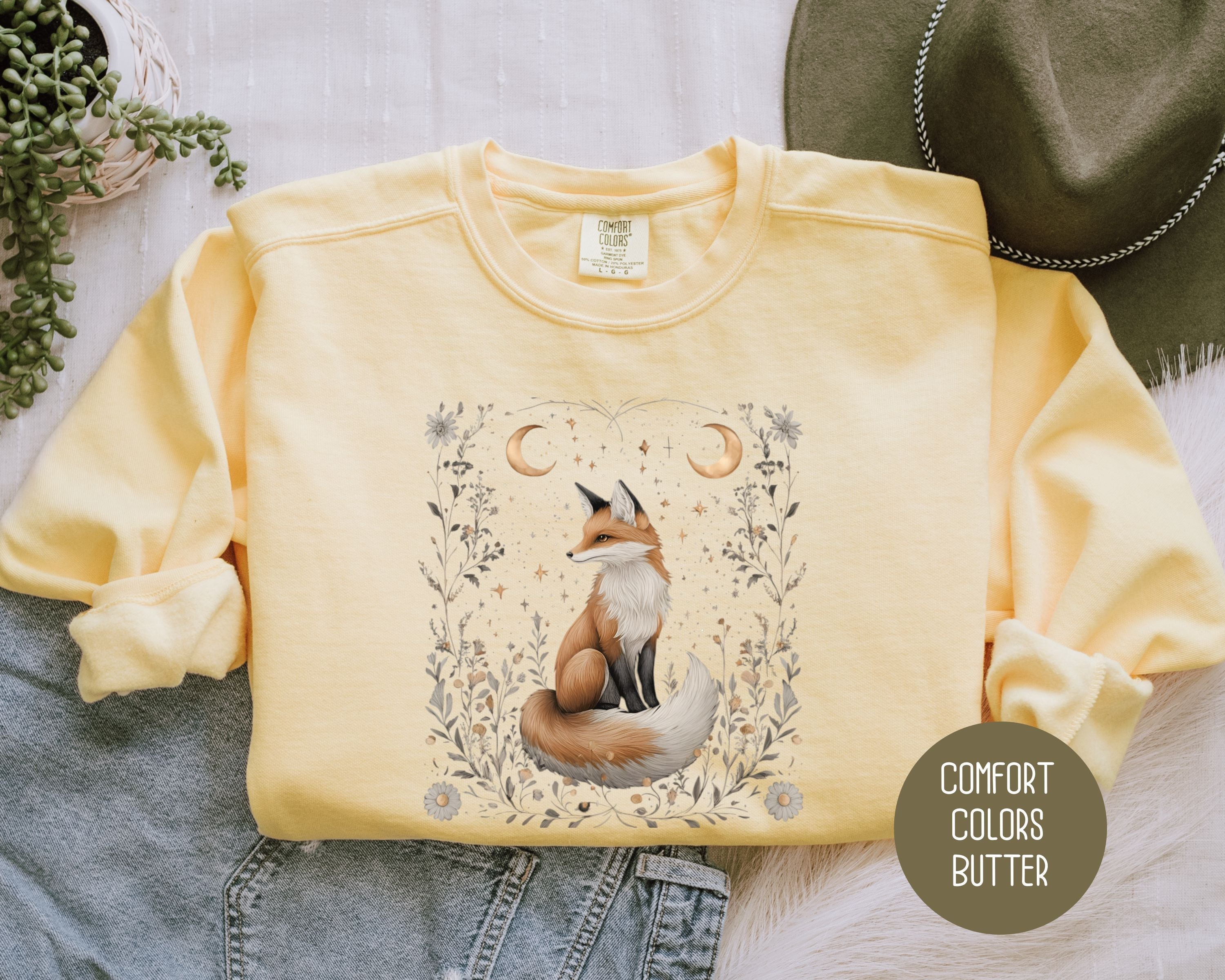 Cream-colored sweatshirts featuring a celestial fox design on the front, with the Starlit Hollow Celestial Fox theme by CreativeSpecialTs.