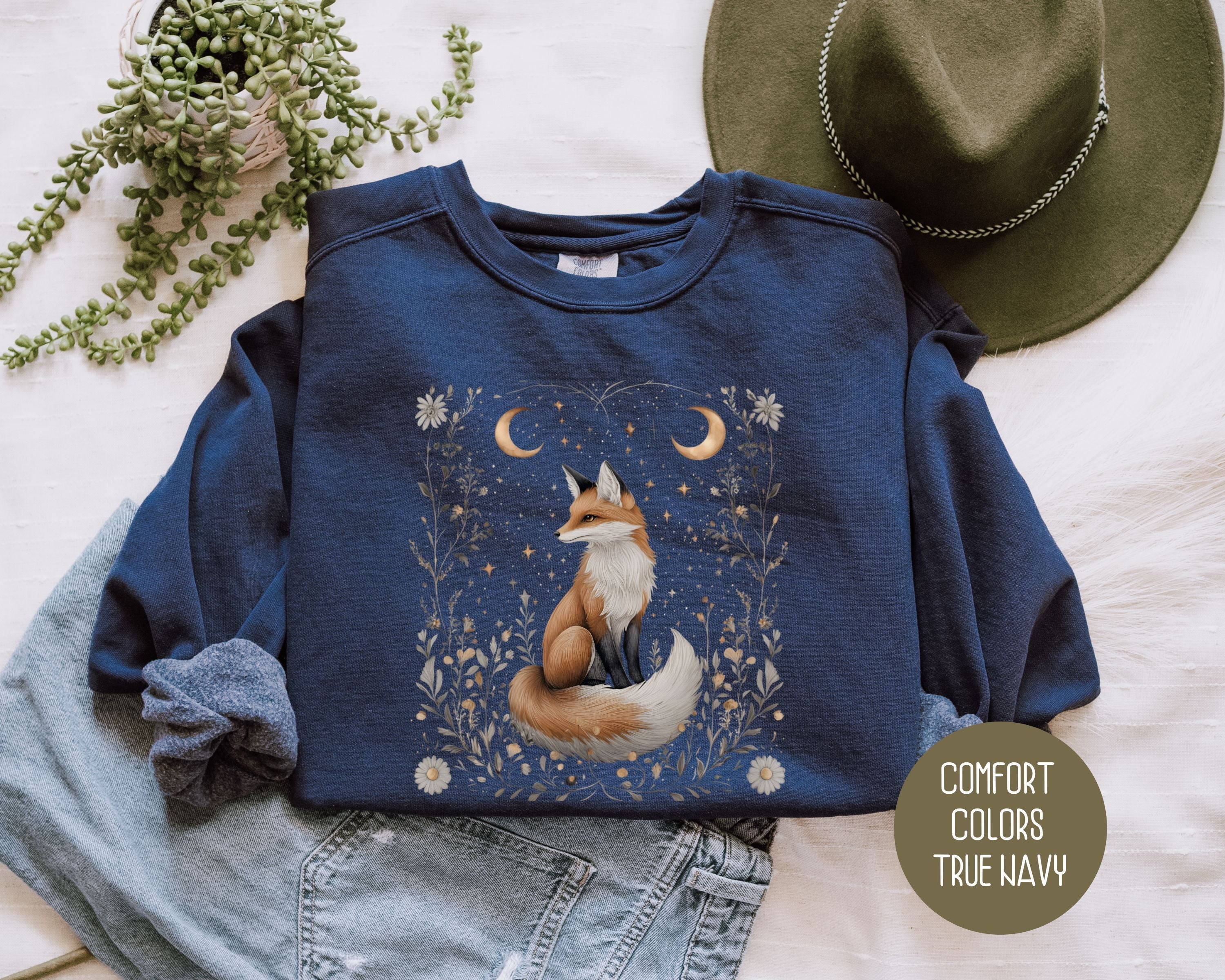 Navy Comfort Colors sweatshirt featuring a starlit hollow celestial fox design on the front, by CreativeSpecialTs.