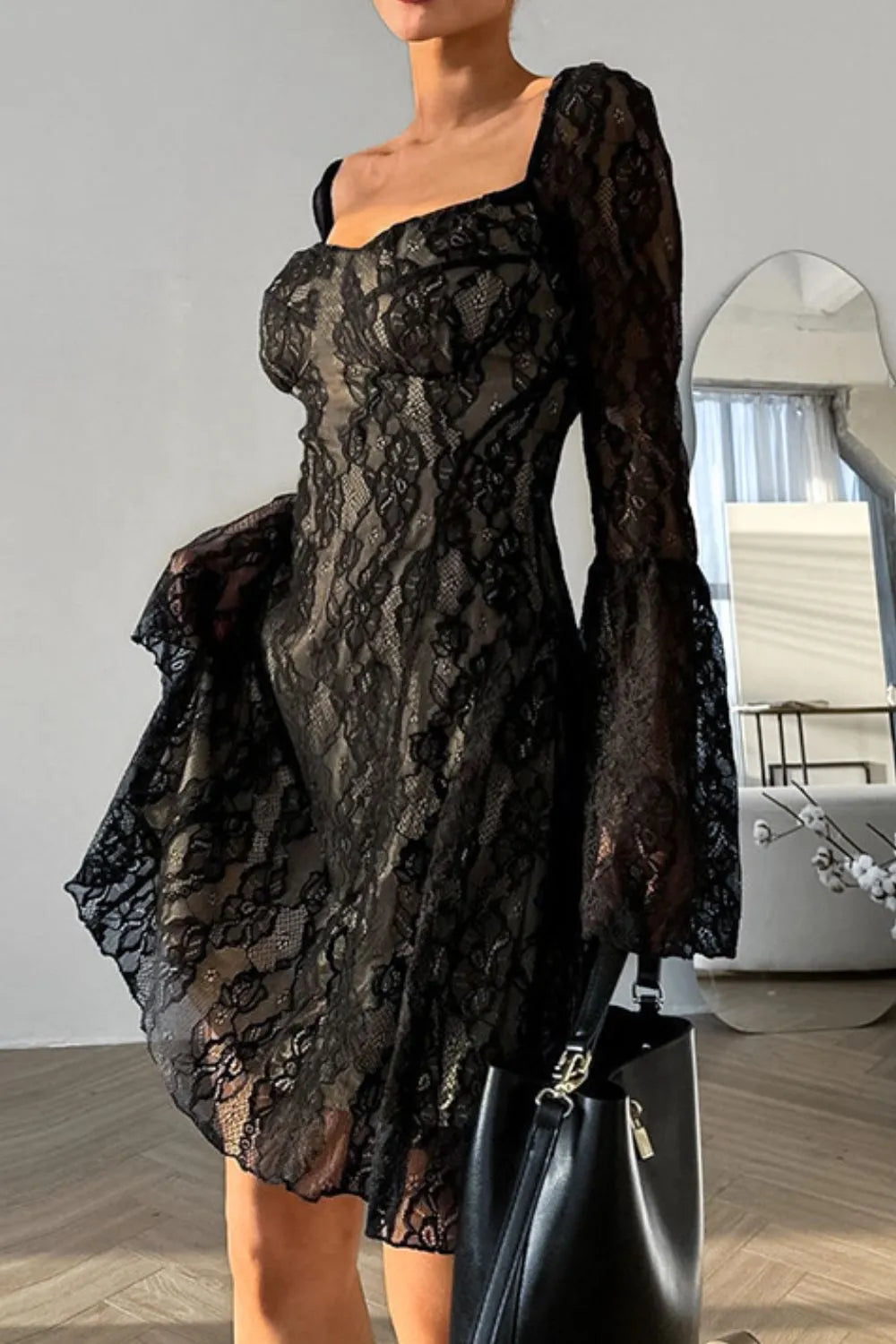 Elegant Starlit Hollow Lace Spell Dress by Trendsi featuring bell sleeves and intricate lace details.