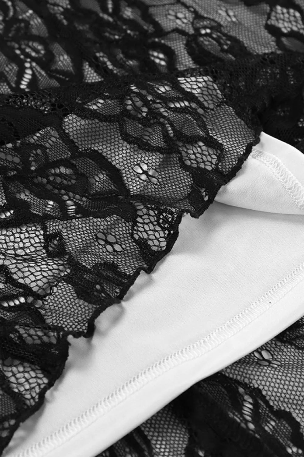 Close-up of the Starlit Hollow Lace Spell Dress by Trendsi, highlighting intricate lace detailing and lining.