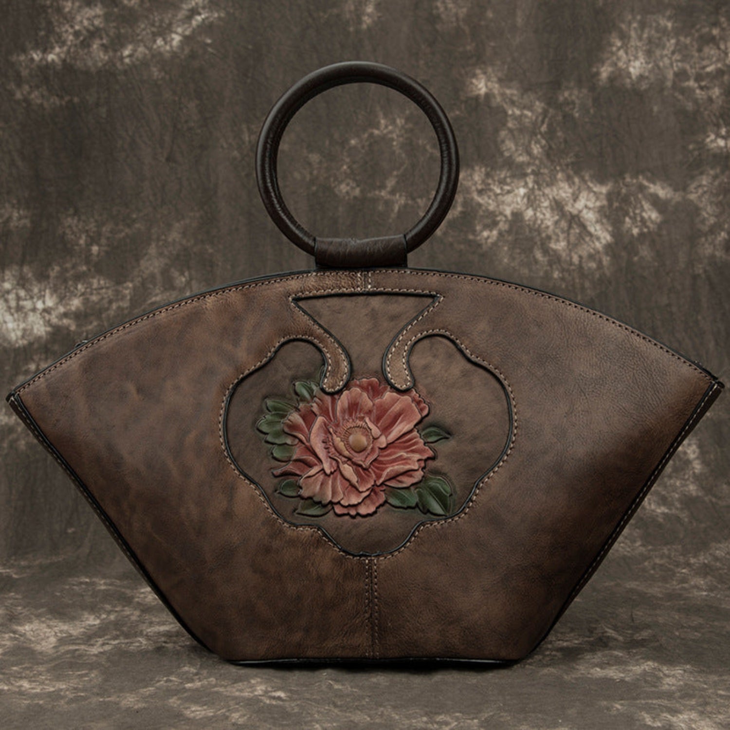 Woodland brown vintage leather Boston bag by cjdropshipping featuring an embossed flower inside a bottle-shaped motif.