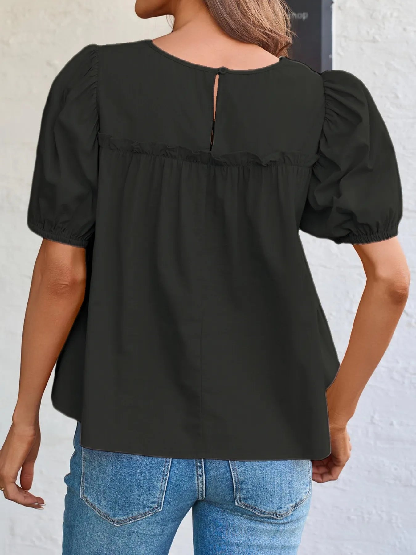 Soft meadow-colored puff sleeve tiered cottage blouse by Trendsi, featuring flowy fabric and feminine design details.