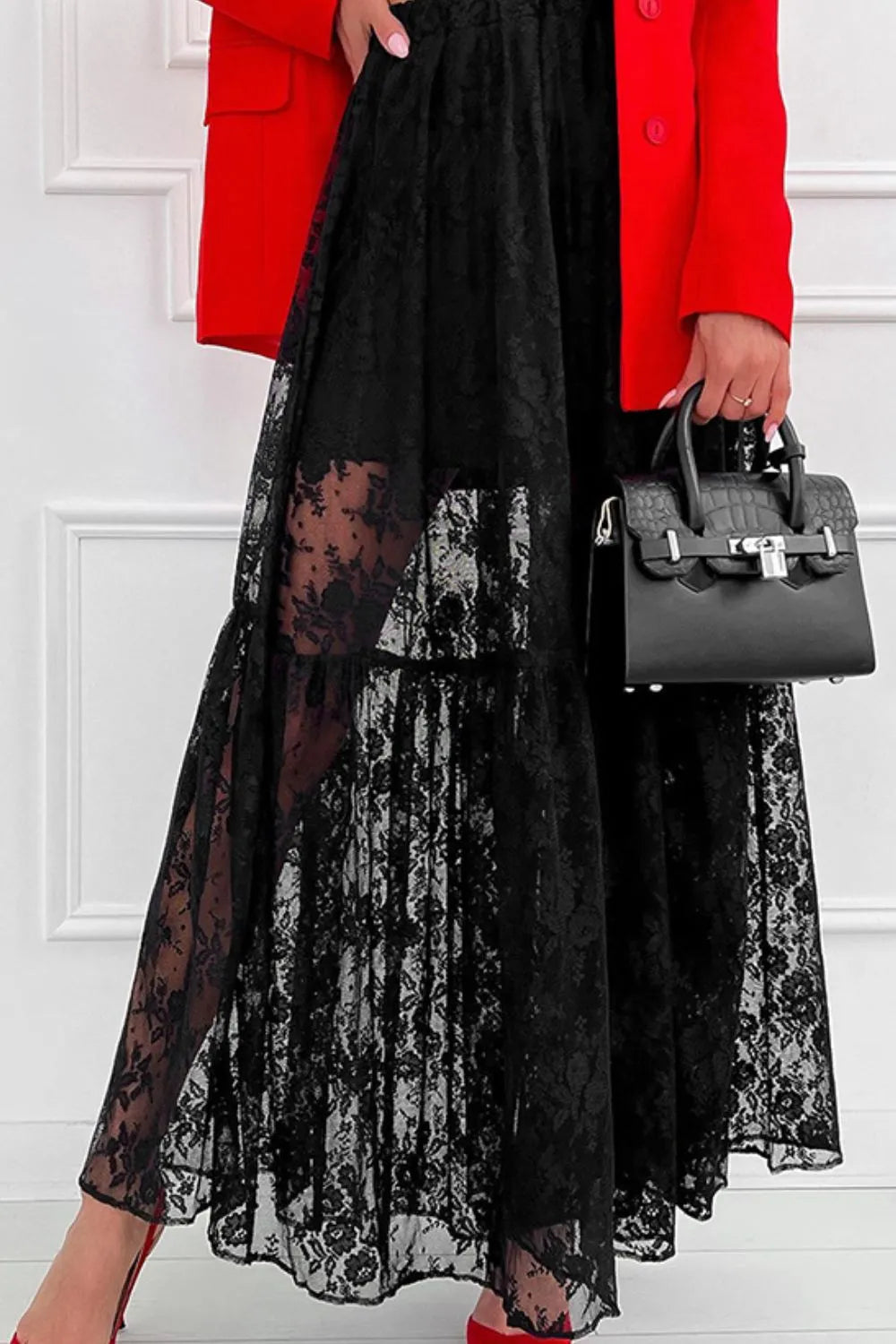 Close-up of black lace detail on Trendsi Lace Dream Maxi Skirt, showcasing intricate lace fabric and flowing maxi design.