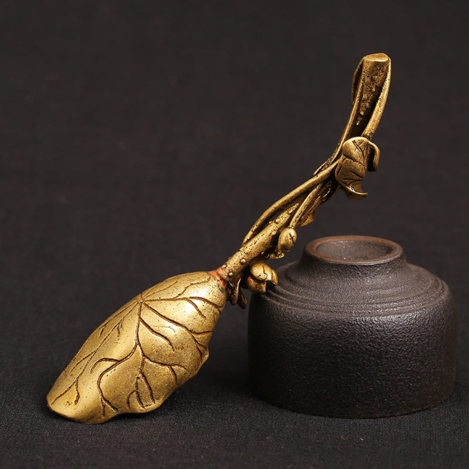 Golden brass lotus leaf tea shovel from CJDropshipping, showing bottom view of the botanical artisan scoop with intricate leaf design.