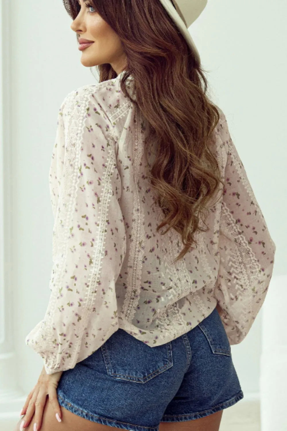 Back view of a Meadow Lace and Frill Tie-Neck Blouse by Trendsi, showcasing delicate lace details and feminine frill accents.