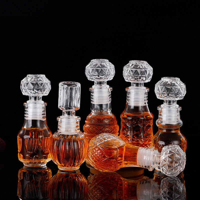 Set of five mini glass wishing bottles in vintage decanter style, perfect for decorative or gifting purposes.