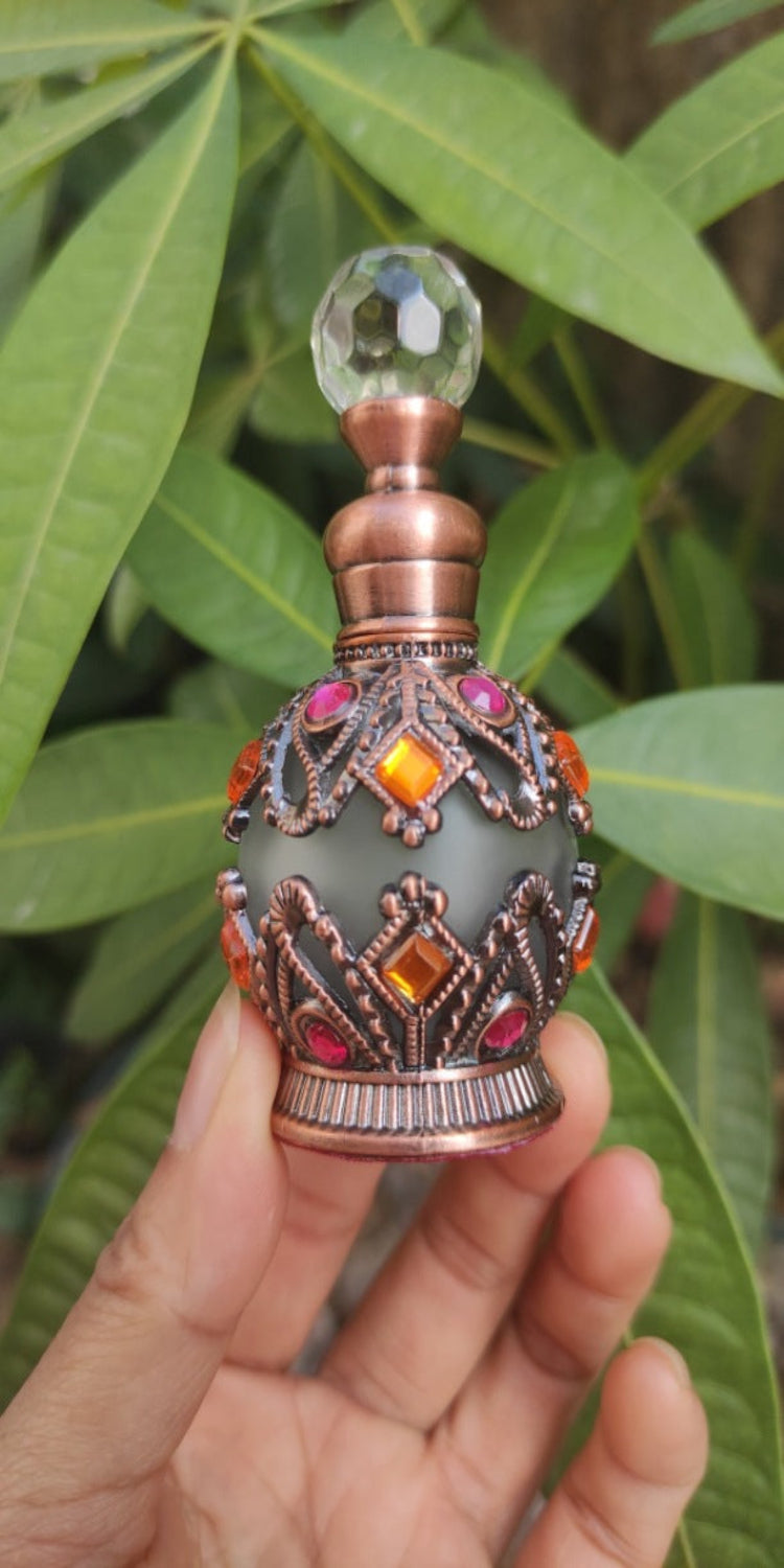 Ornate silver 15ml glass essential oil bottle with decorative design, perfect for perfume or potion storage.