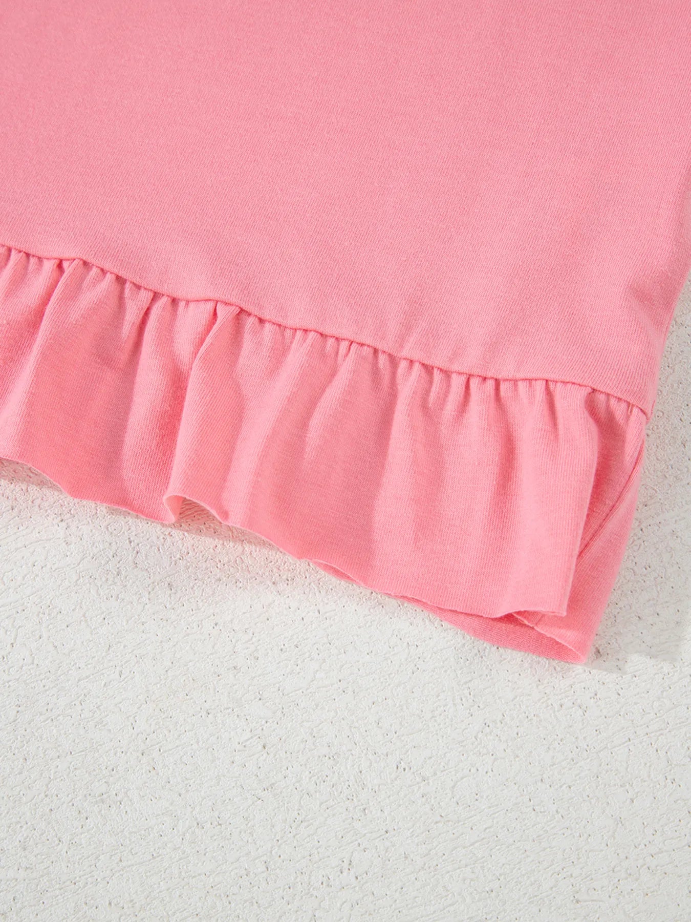 Pale blush ruffle hem cottage T-shirt with round neck and ruffle details, stylish casual top by Trendsi
