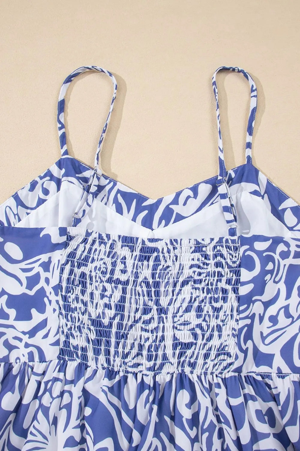 Close-up of the back of a whimsical bluebell-colored sundress with spaghetti straps from Trendsi, showcasing delicate fabric details.