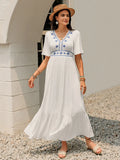 White Briar Cottage Dress by Trendsi featuring a front view of a lightweight, flowy white dress on a model.