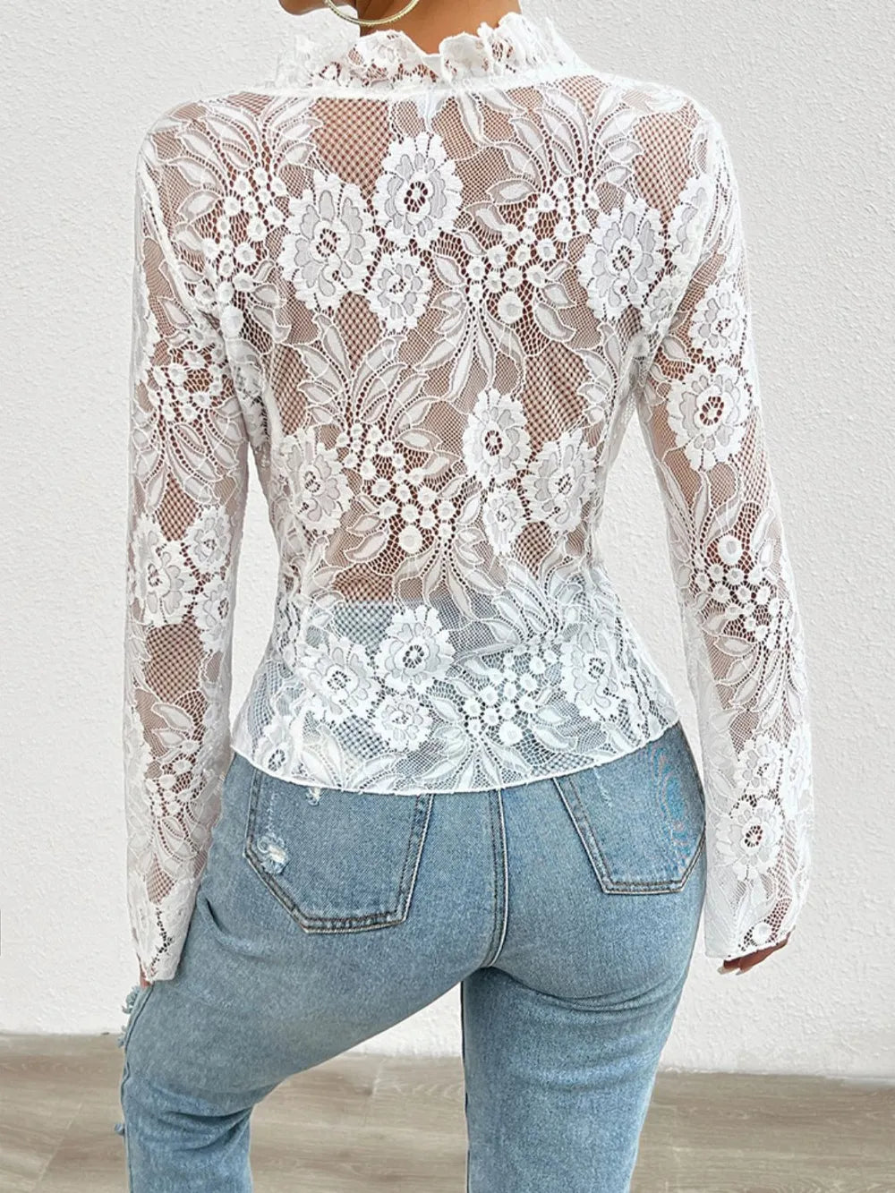 White lace-tied V-neck blouse with sheer sleeves, from Trendsi, shown from the back. Elegant and feminine fashion top.